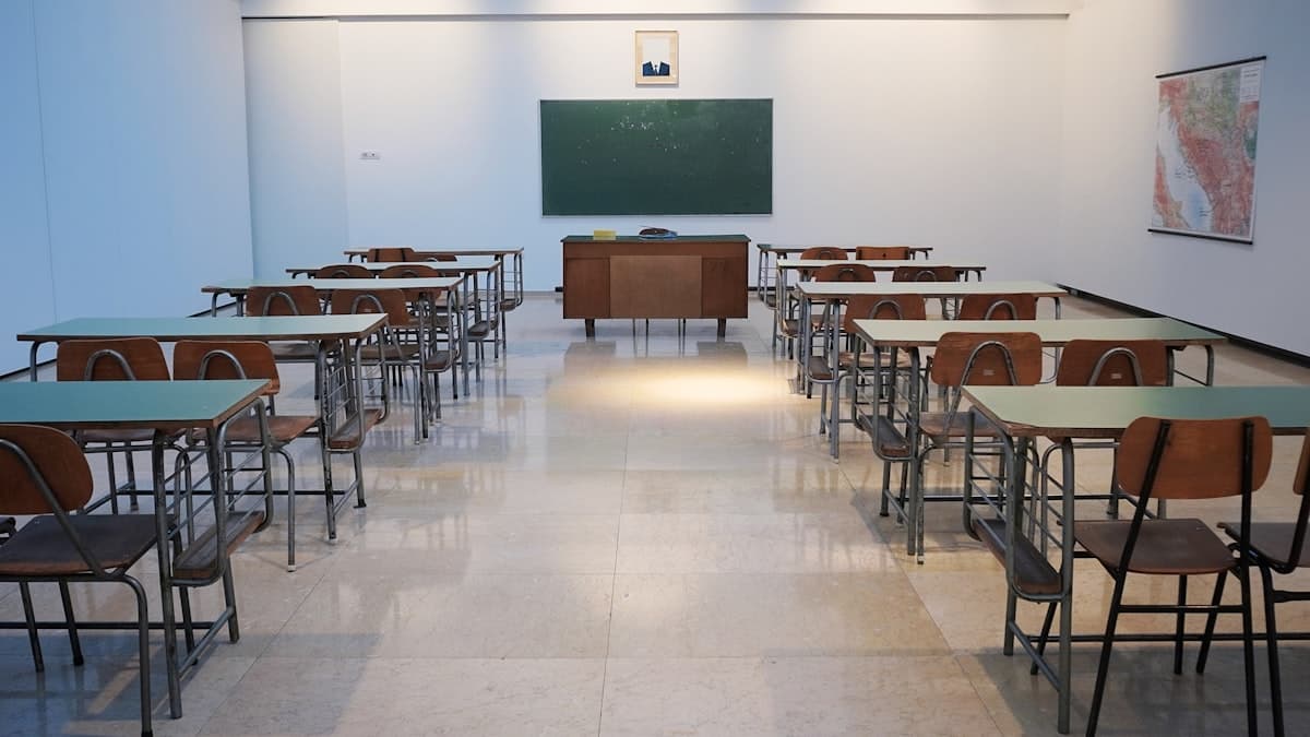 Empty classroom with desks facing a chalkboard