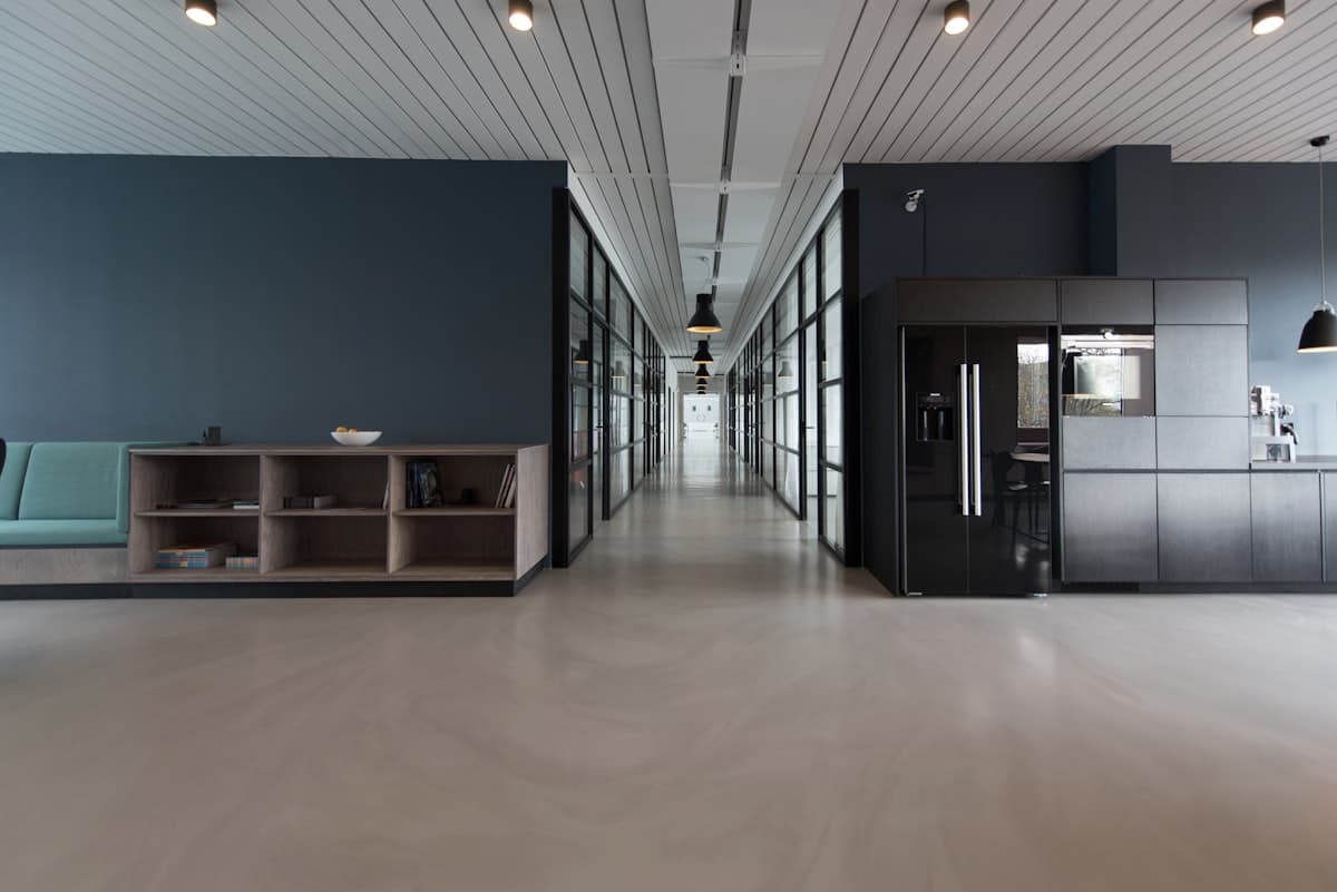 Modern office workspace with kitchen and IT equipment